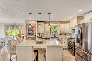 Kitchen with stainless appliances and custom cabinets.