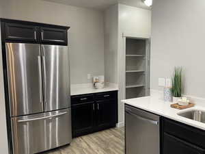 Kitchen with stainless steel appliances and prep area with new quartz countertop.