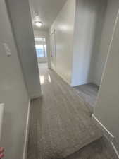 Third-floor hallway leading to the master bedroom, laundry, and third bedroom.