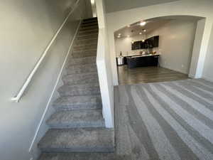 Family room with stairs leading to the third floor.