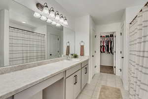 Bathroom with tile patterned flooring and vanity