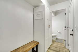 Bathroom with wood-type flooring and toilet