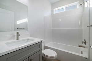 Full bathroom featuring vanity, shower / bathtub combination, and toilet