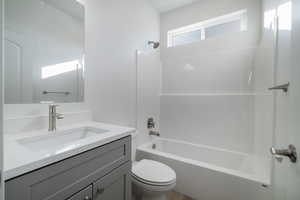 Full bathroom with vanity, toilet, and washtub / shower combination