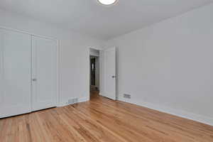 Unfurnished bedroom with light hardwood / wood-style flooring