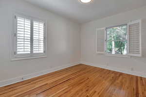 Unfurnished room featuring light wood-type flooring and plenty of natural light