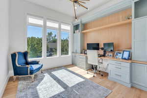 Front office with built in desks and white oak flooring.