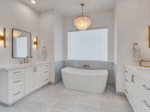 Deluxe primary bath with marble and natural stone tilework