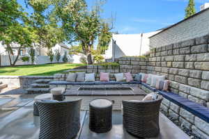 Huge outdoor entertaining space which opens from basement family room with firepit and outdoor seating.