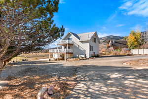 View of front of home with a balcony and a mountain view