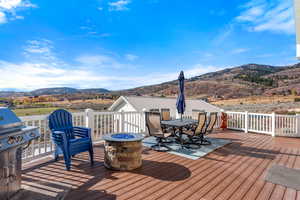 Trex deck featuring a mountain view and a fire pit