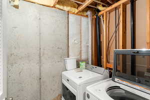 Washroom with washing machine and clothes dryer
