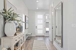 Entrance foyer featuring light wood-type flooring and a textured ceiling