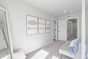 Bedroom featuring light colored carpet