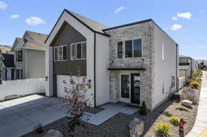 Contemporary house with central air condition unit and a garage