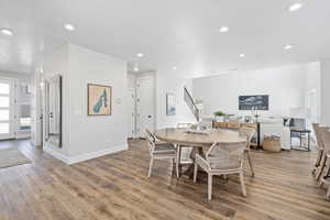 Dining area with wood-type flooring and a textured ceiling