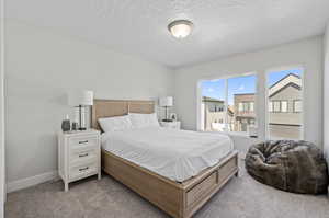 Carpeted bedroom with a textured ceiling