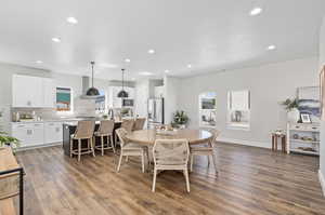 Dining space with light hardwood / wood-style floors and a textured ceiling