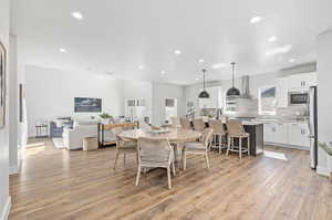 Dining area featuring a textured ceiling and light hardwood / wood-style flooring