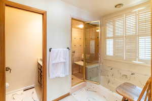 Bathroom featuring vanity, an enclosed shower, and toilet