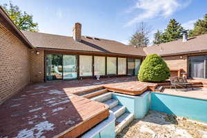 View of pool featuring a wooden deck