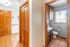 Bathroom featuring vanity, toilet, and tile patterned floors