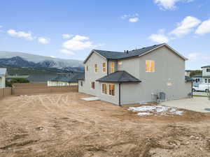 Rear view of property featuring heat-pump A/C unit and a mountain view