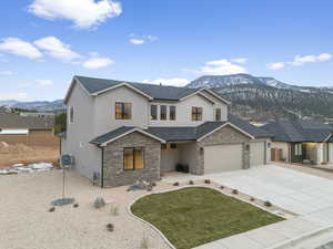 View of front of house featuring a mountain view and central AC unit