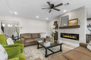 Living room featuring light wood-type flooring and ceiling fan