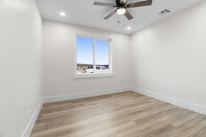 Main level flex room/bedroom featuring light hardwood / wood-style flooring and ceiling fan