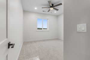 Carpeted bedroom room with ceiling fan
