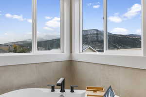 Primary ensuite soaking tub with mountain view