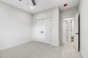 Carpeted bedroom room with ceiling fan