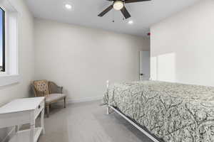 Bedroom with light colored carpet and ceiling fan