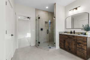 Primary bedroom ensuite bath with tile patterned flooring, dual vanities, and full tile shower with separate bathtub