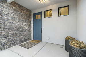 Entrance to home with covered porch