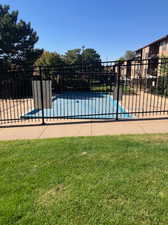 View of swimming pool featuring a lawn