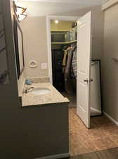 Sink in bedroom featuring hardwood / wood-style flooring and vanity