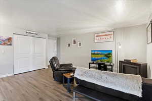 Interior space featuring wood-type flooring and a textured ceiling