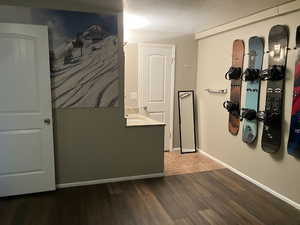 Hall with hardwood / wood-style floors and a textured ceiling