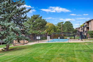 Surrounding community featuring a yard and a pool