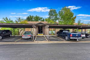 View of vehicle parking featuring a carport