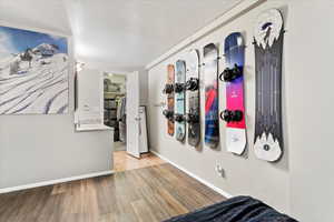 Interior space with light hardwood / wood-style floors and a textured ceiling