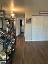 Hall with dark wood-type flooring and a textured ceiling