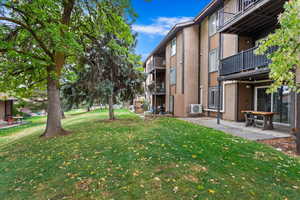 View of property's community featuring a yard and a patio area