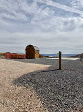 View of yard with a water view and a storage unit