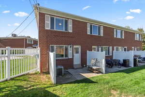 Back of property featuring a yard, a patio area, and central AC unit