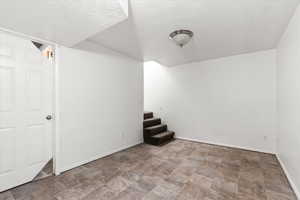 Basement with a textured ceiling