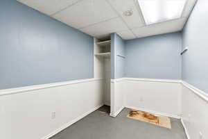 Unfurnished room with a drop ceiling