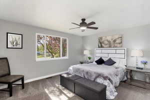 Bedroom featuring ceiling fan and carpet flooring